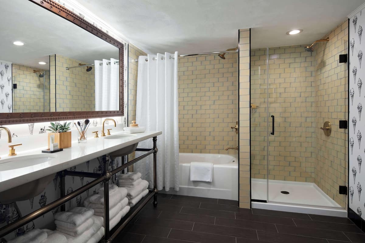 combined shower/bathtub, designer toiletries, hair dryer, towels