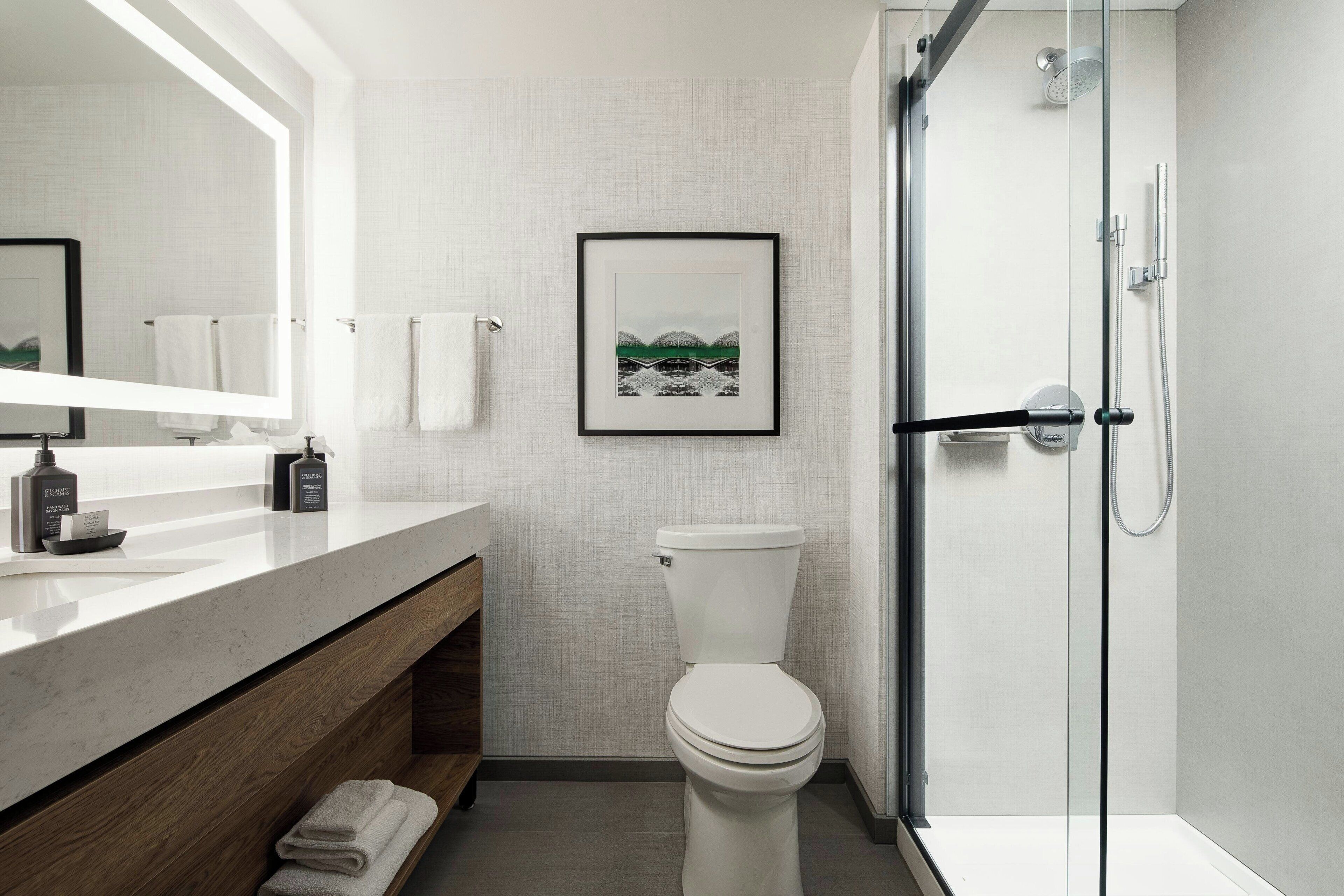 combined shower/bathtub, designer toiletries, hair dryer, towels