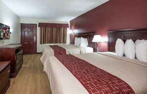 A hotel room with two beds, a wooden dresser, a TV, and a door. - Red Roof Inn Chipley (Chipley)