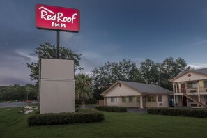 Surrounded by lush landscaping, the Red Roof Inn offers a tranquil atmosphere.