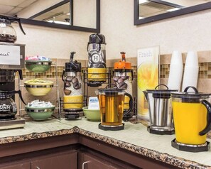 A buffet setup with various drink dispensers, including hot water, regular water, and coffee options. - Townhouse Winston Salem - University (Winston-Salem)