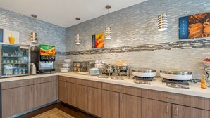 A modern kitchen with stainless steel appliances, a refrigerator, and a coffee machine. - Best Western Hilliard Inn & Suites (Hilliard)