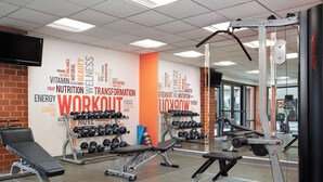 A gym with various exercise equipment, a wall with motivational words, and a television mounted on the wall. - Holiday Inn Washington-Dulles International Airport by IHG (Sterling)