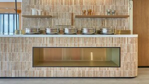 A modern kitchen with a marble backsplash, stainless steel appliances, and a built-in glass display shelf. - ibis Perth (Perth)