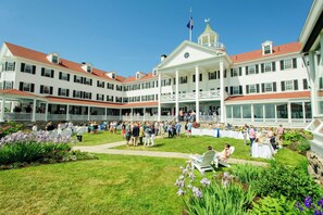 A large, multi-story building with a central courtyard surrounded by a covered walkway. - The Colony Hotel (Kennebunkport)