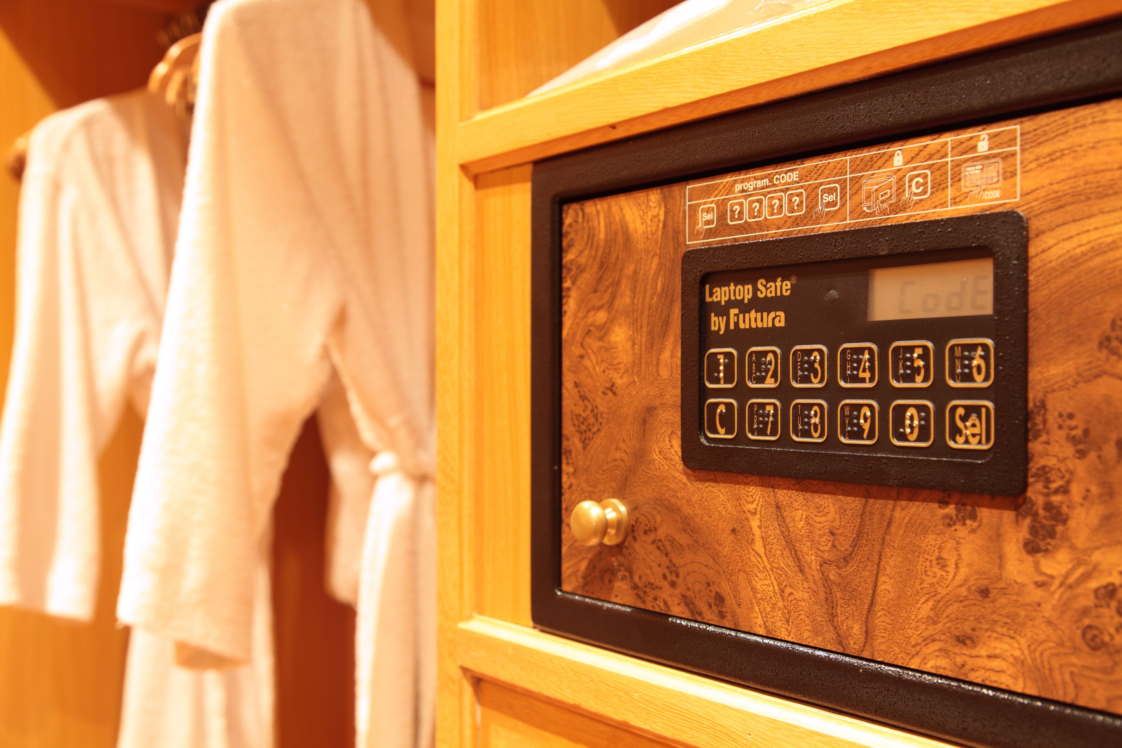 A wooden-framed safe with a keypad and a digital display, likely for securing valuables.
