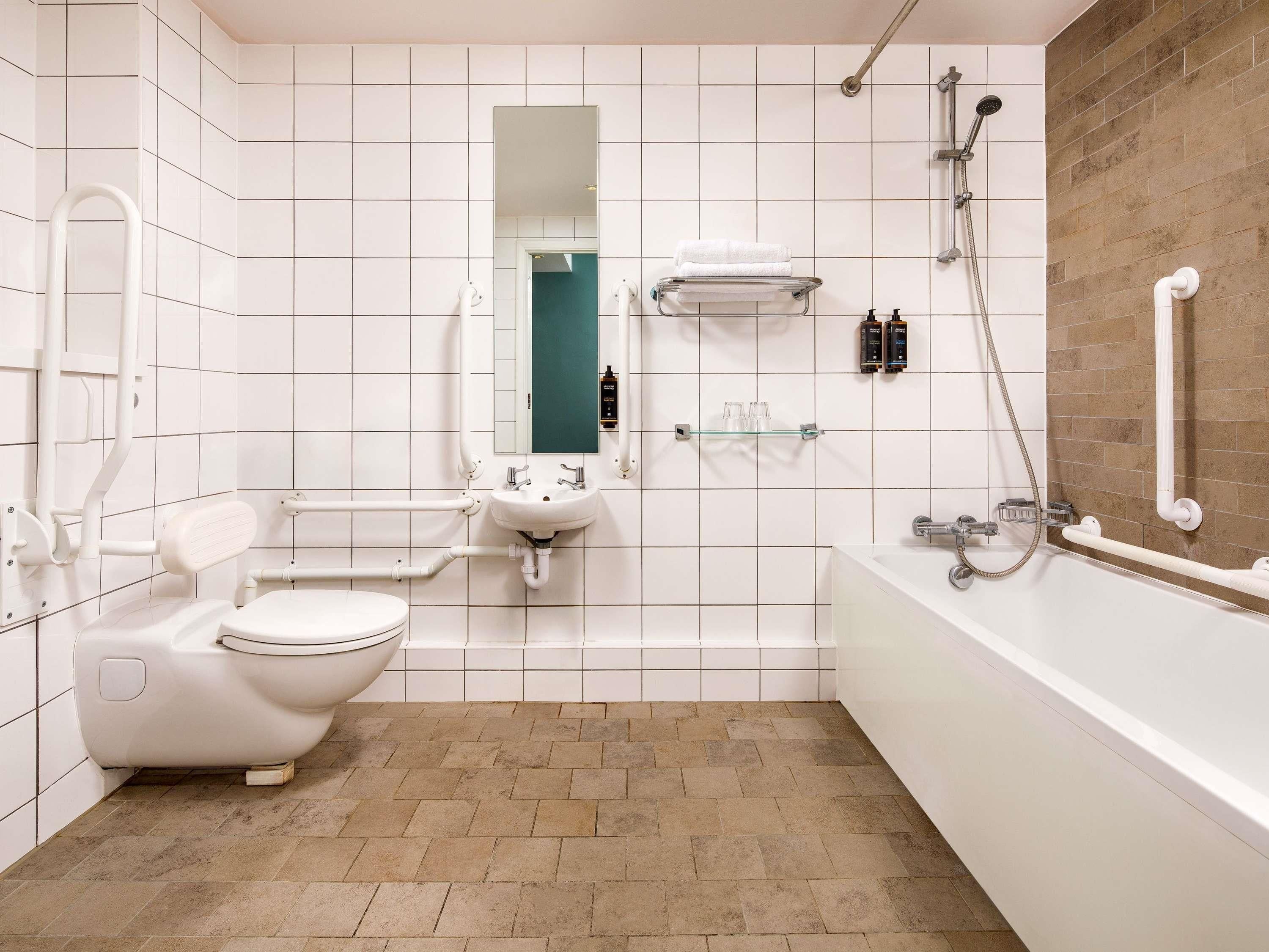 A modern bathroom with a toilet, sink, and shower.