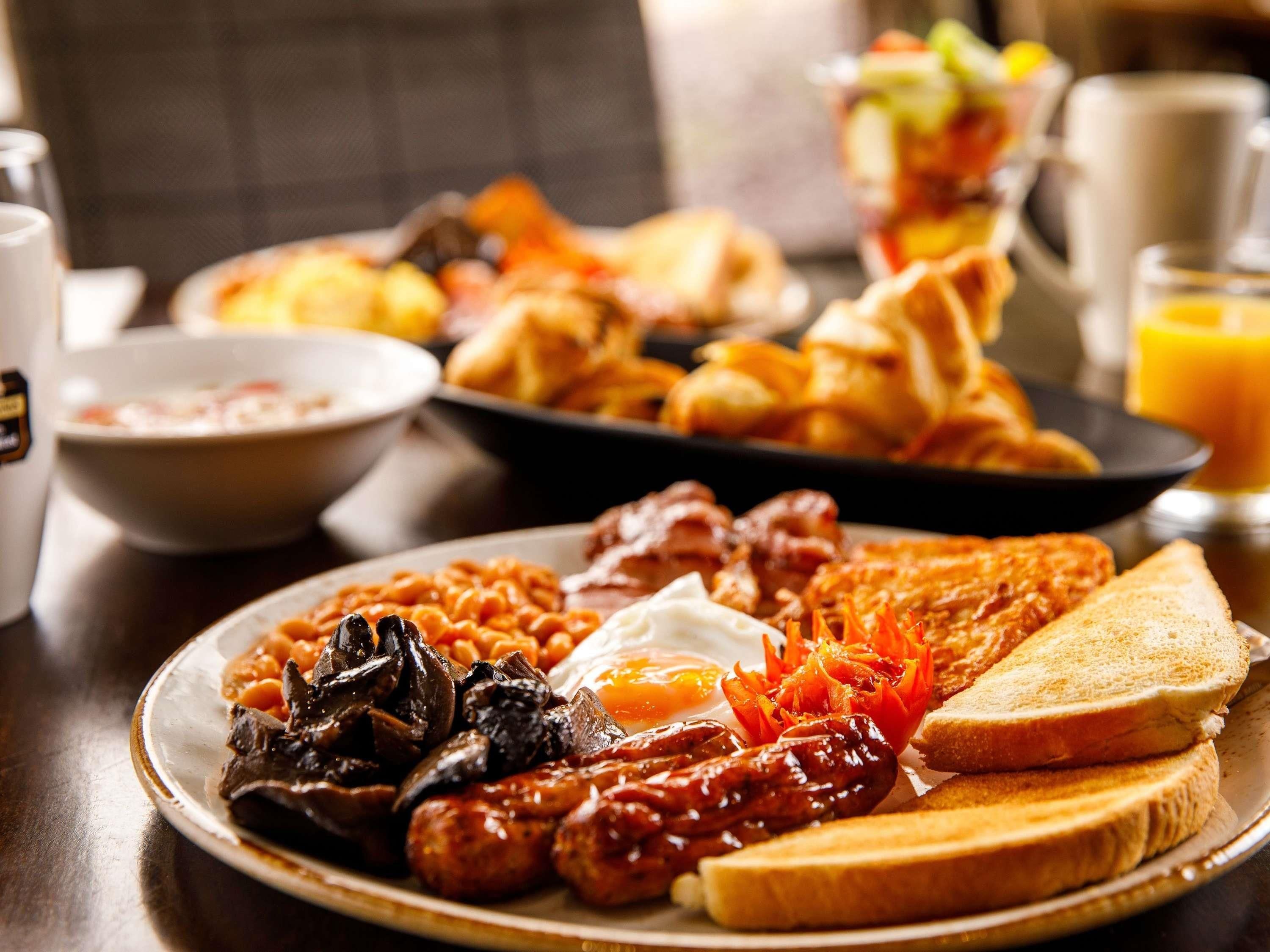 A breakfast plate with sausages, eggs, mushrooms, and toast.
