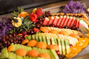 A fruit platter with various fruits and vegetables.
