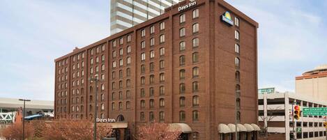 A Days Inn hotel with a brick facade, multiple windows, and a sign indicating a restaurant.
