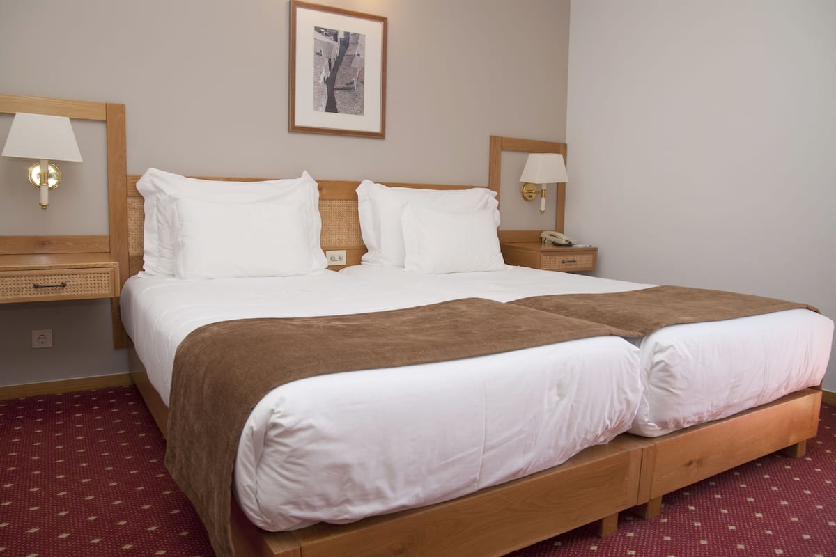 Double or Twin Room | Minibar, in-room safe, desk, blackout drapes