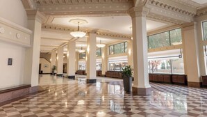 A spacious lobby with high ceilings, large windows, and a checkered floor. - Drury Plaza Hotel Broadview - Wichita (Wichita)