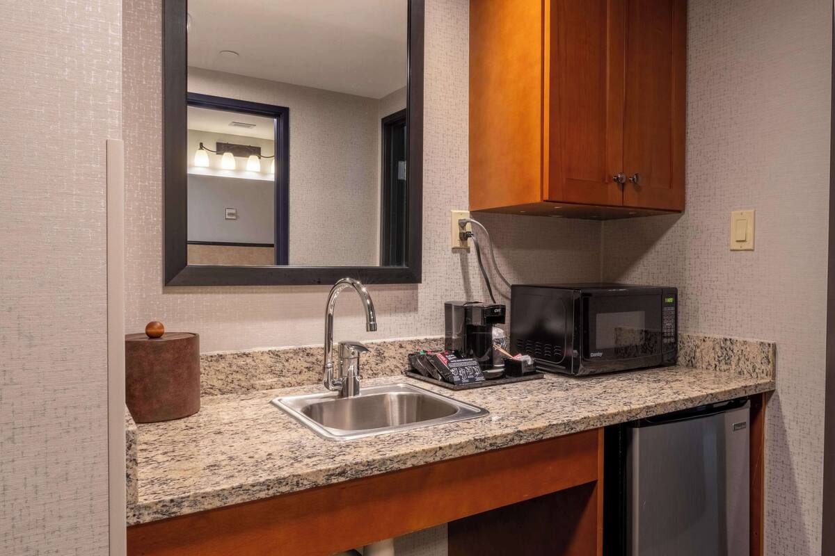 suite, 1 king bed with sofa bed, accessible, refrigerator & microwave (2 rooms, roll in shower) | 1 bedroom, desk, blackout curtains, iron/ironing board