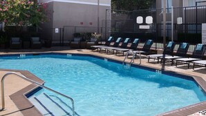 A swimming pool with a tiled edge, a metal ladder, and lounge chairs. - Sonesta ES Suites Dallas Medical Market Center (Dallas)