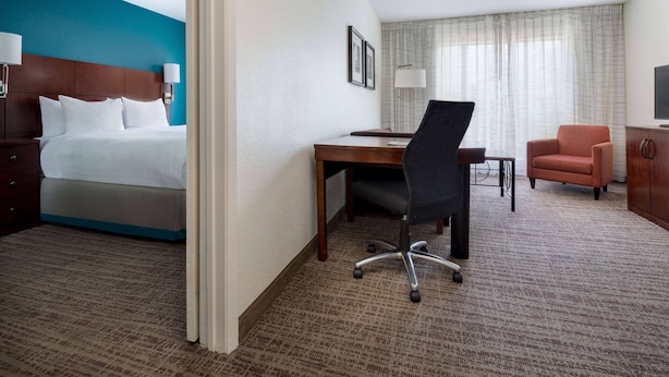 Premium bedding, desk, laptop workspace, blackout drapes