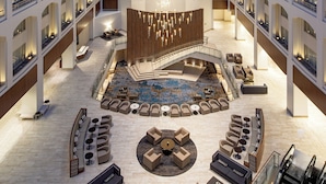 A spacious lobby with a central seating area, a staircase, and multiple balconies. - Grand Hyatt Washington (Washington)