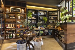A well-organized retail space with shelves stocked with various products, including wine, snacks, and packaged goods. - Casa Mani Resort Napa Valley, Curio Collection by Hilton (Napa)