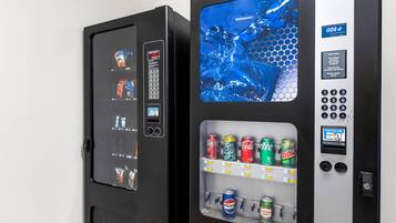 Two vending machines with a variety of beverages and snacks.