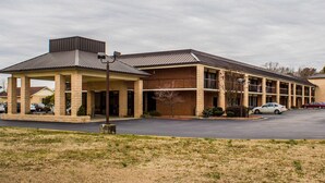A two-story building with a covered entrance and a parking lot.