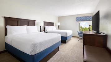 Standard room with two double beds | In-room safe, desk, laptop workspace, iron/ironing board