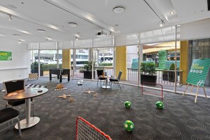 A children's play area with tables, chairs, and soccer goals. - Holiday Inn Sydney Potts Point by IHG (Potts Point)