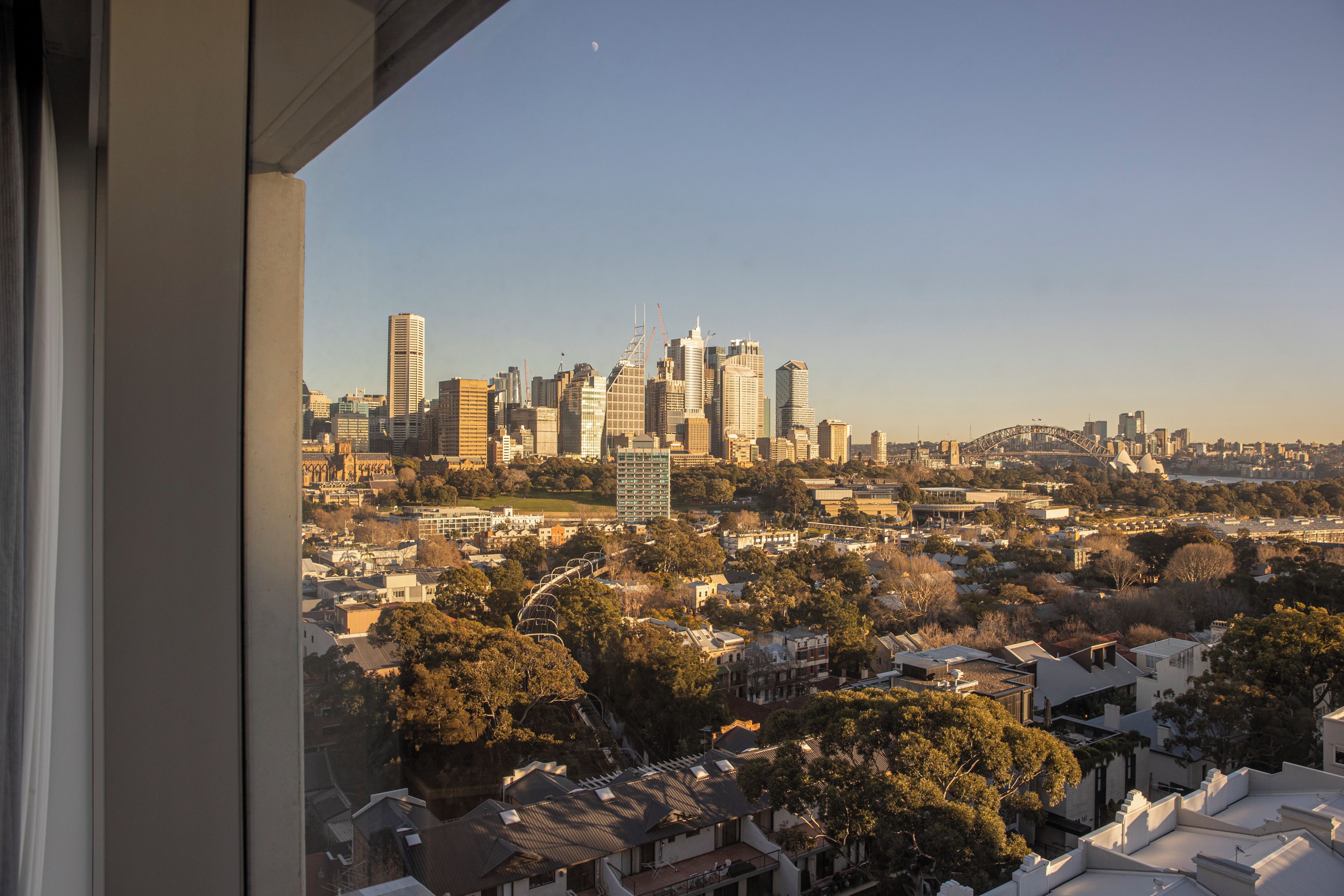 A cityscape with high-rise buildings, a bridge, and a mix of residential and commercial structures.