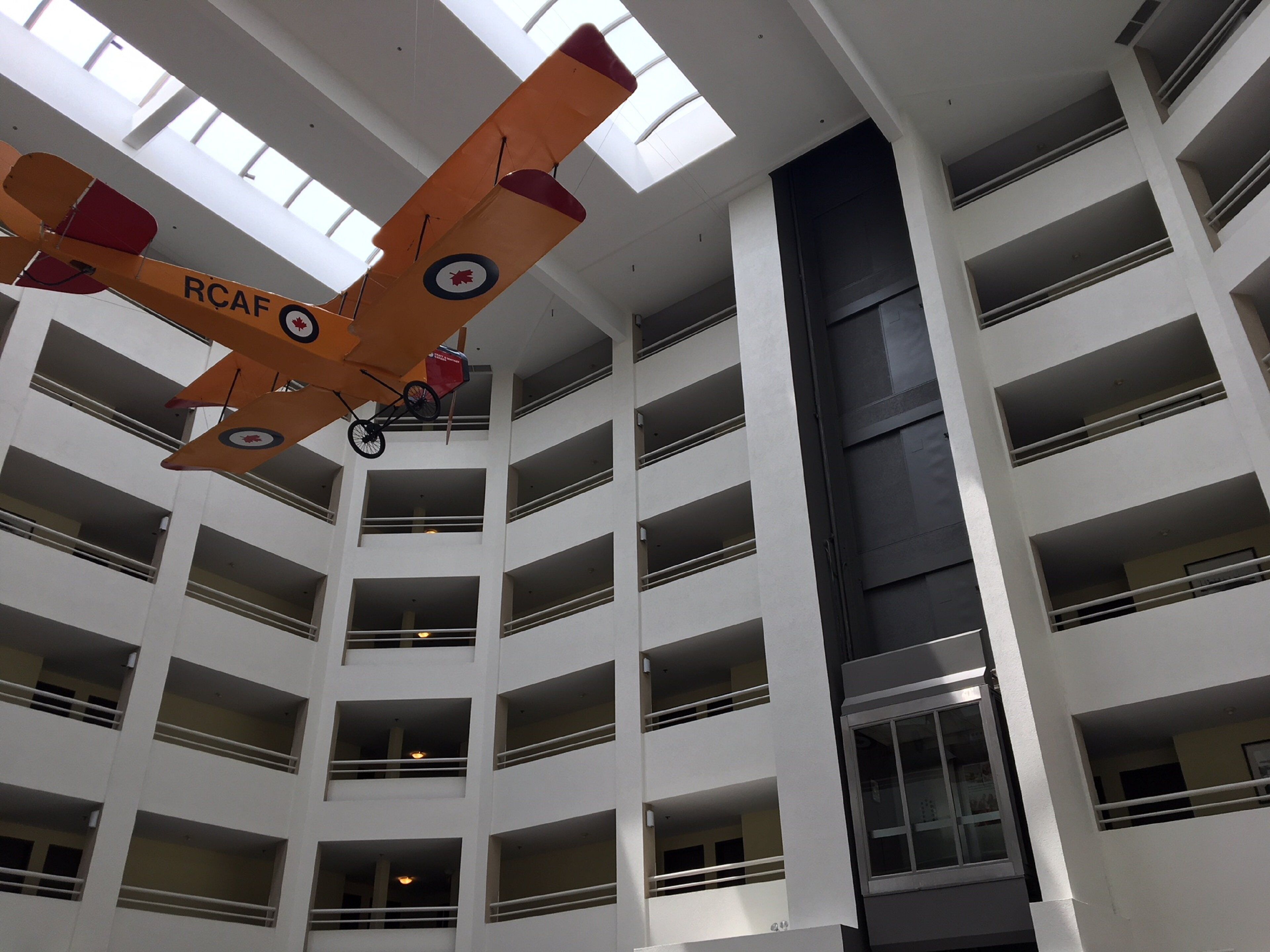 A multi-level building with a suspended aircraft model.