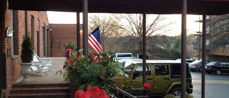 The Historic Brookstown Inn entrance with a brick building, American flag, and a Jeep with a red bow.