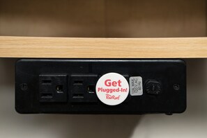A power strip with a "Get Plugged-In!" badge and a label indicating "120V AC 60 Hz". - Red Roof Inn Hilton Head Island (Hilton Head Island)