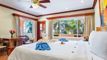 Relax in this serene space with a large bed, two side tables, and a cozy seating area.