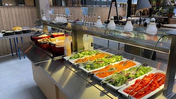 A buffet with various food items and condiments.