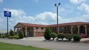 A hotel with a red roof, a covered entrance, and a sign indicating it is an Ameris Best Value Inn. - Americas Best Value Inn Blue Ridge (Blue Ridge)