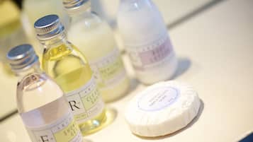 Bottles of liquid soap and a bar of soap on a counter.