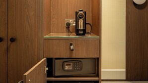 A compact room with a wooden wardrobe, a glass shelf with a coffee maker, a microwave, and a mini-fridge. - Nevis Bank Inn (Fort William)