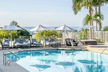 2 outdoor pools, pool umbrellas, sun loungers at Laguna Cliffs Marriott Resort and Spa