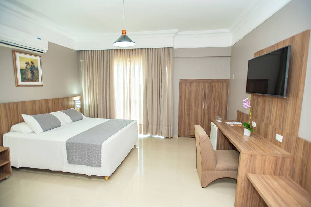 Deluxe Double Room | Minibar, desk, laptop workspace, blackout drapes
