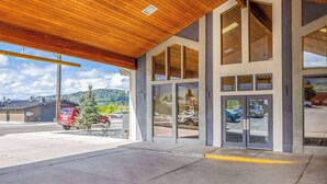 A modern building with large windows and a covered entrance area.