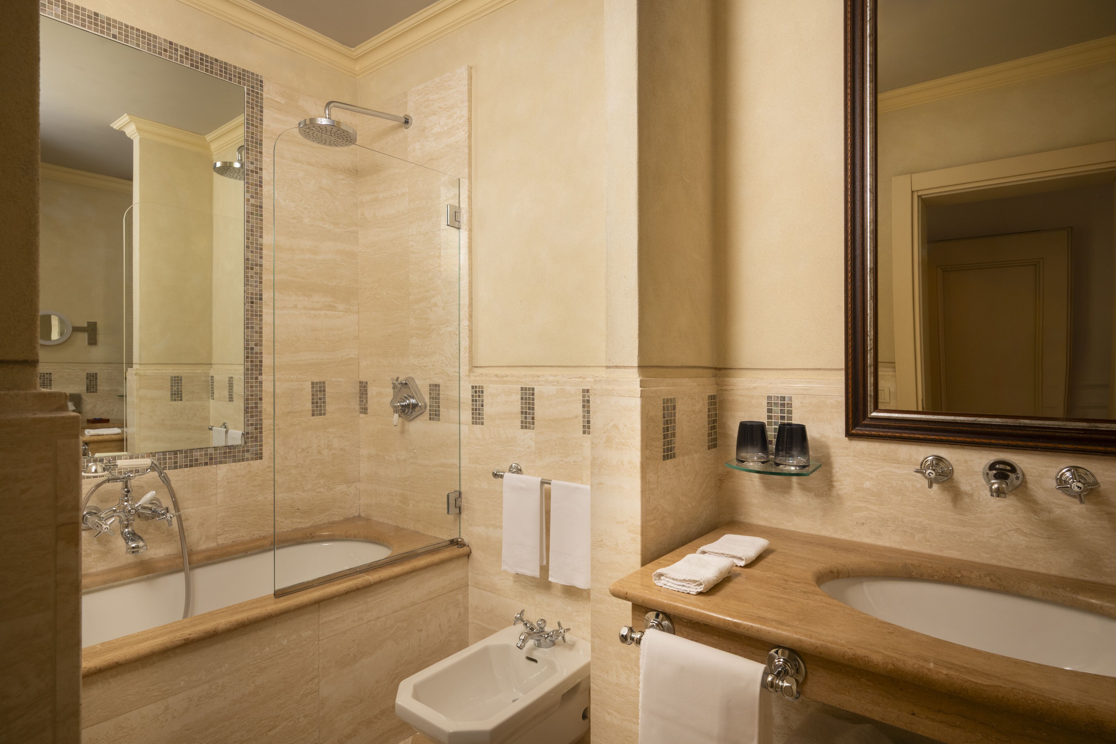A bathroom with a bathtub, a sink, a shower, and a bidet.