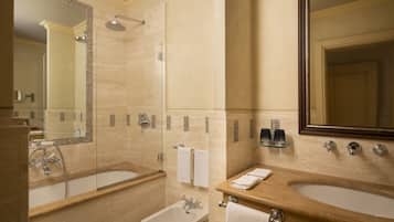 A bathroom with a bathtub, a sink, a shower, and a bidet.