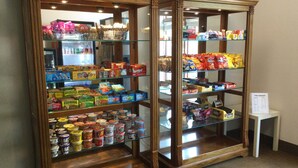 Two wooden display cases containing various snacks and food items. - The Hotel Ojibway, Trademark Collection by Wyndham (Sault Ste. Marie)
