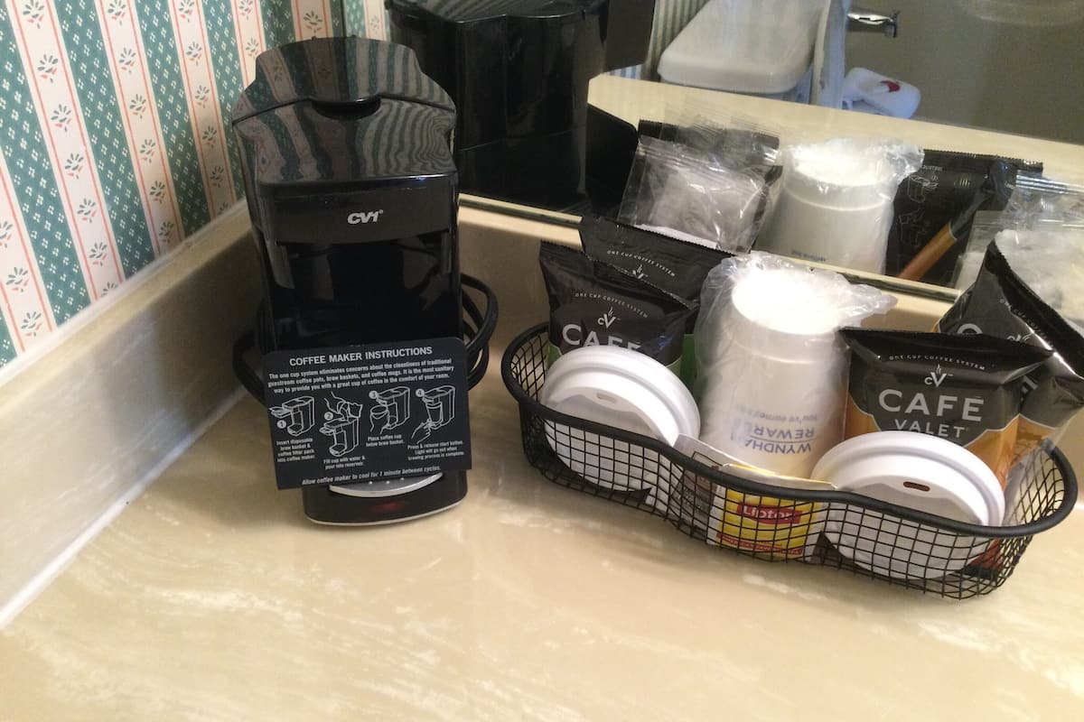 A coffee maker and coffee pods on a kitchen counter.
