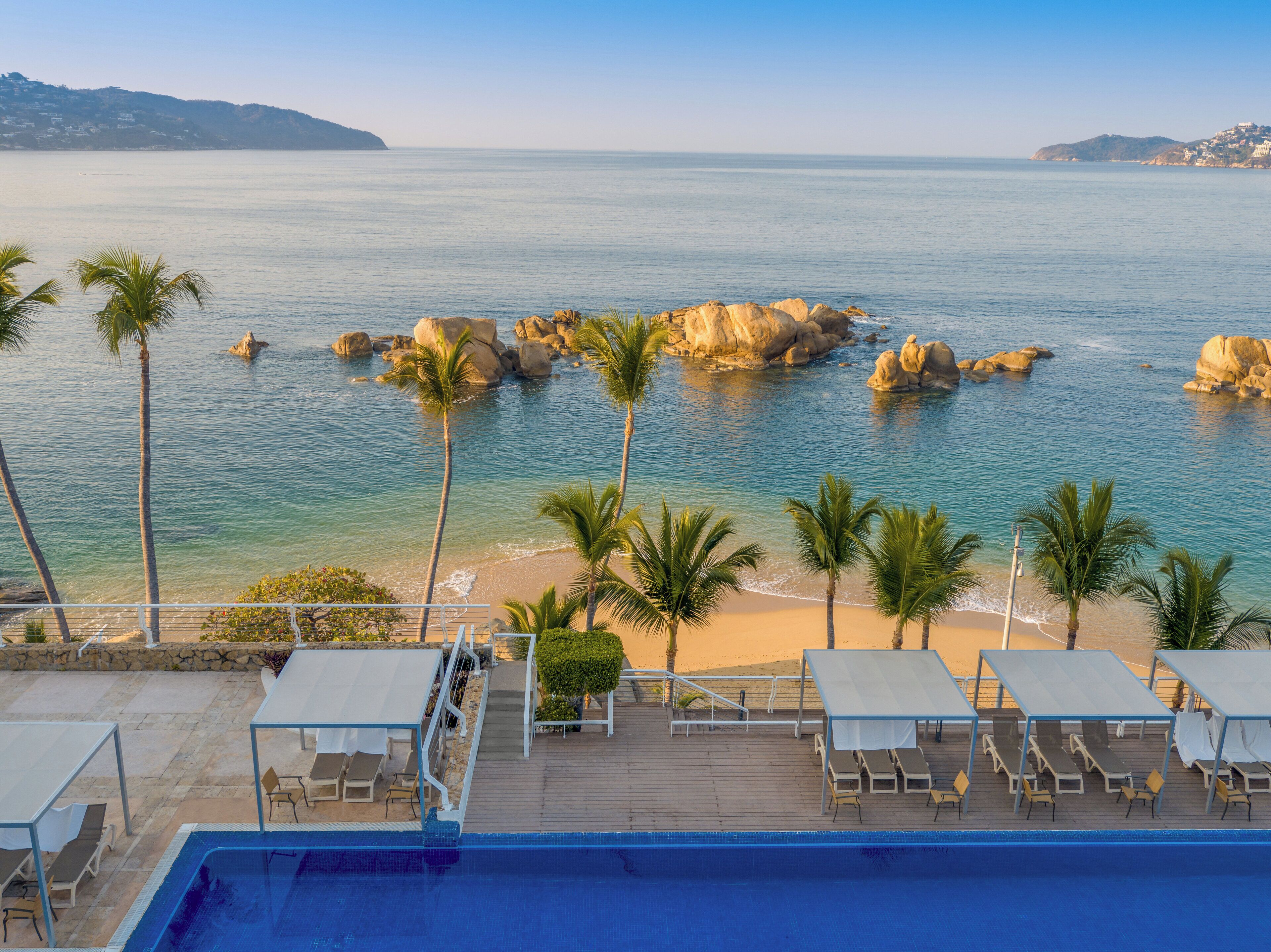 on the beach, sun-loungers, beach umbrellas, beach towels