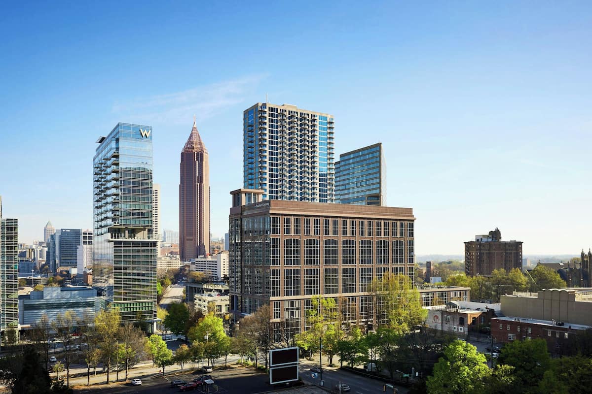 A cityscape with modern high-rise buildings, including a distinctive tower with a spire.