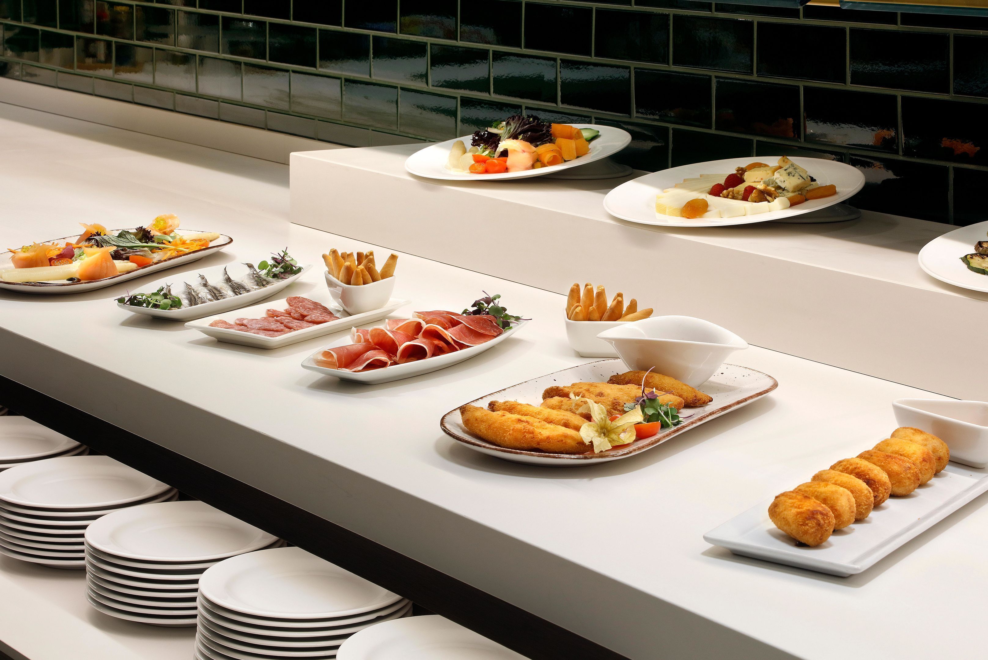 A buffet with various dishes including seafood, meats, and bread.