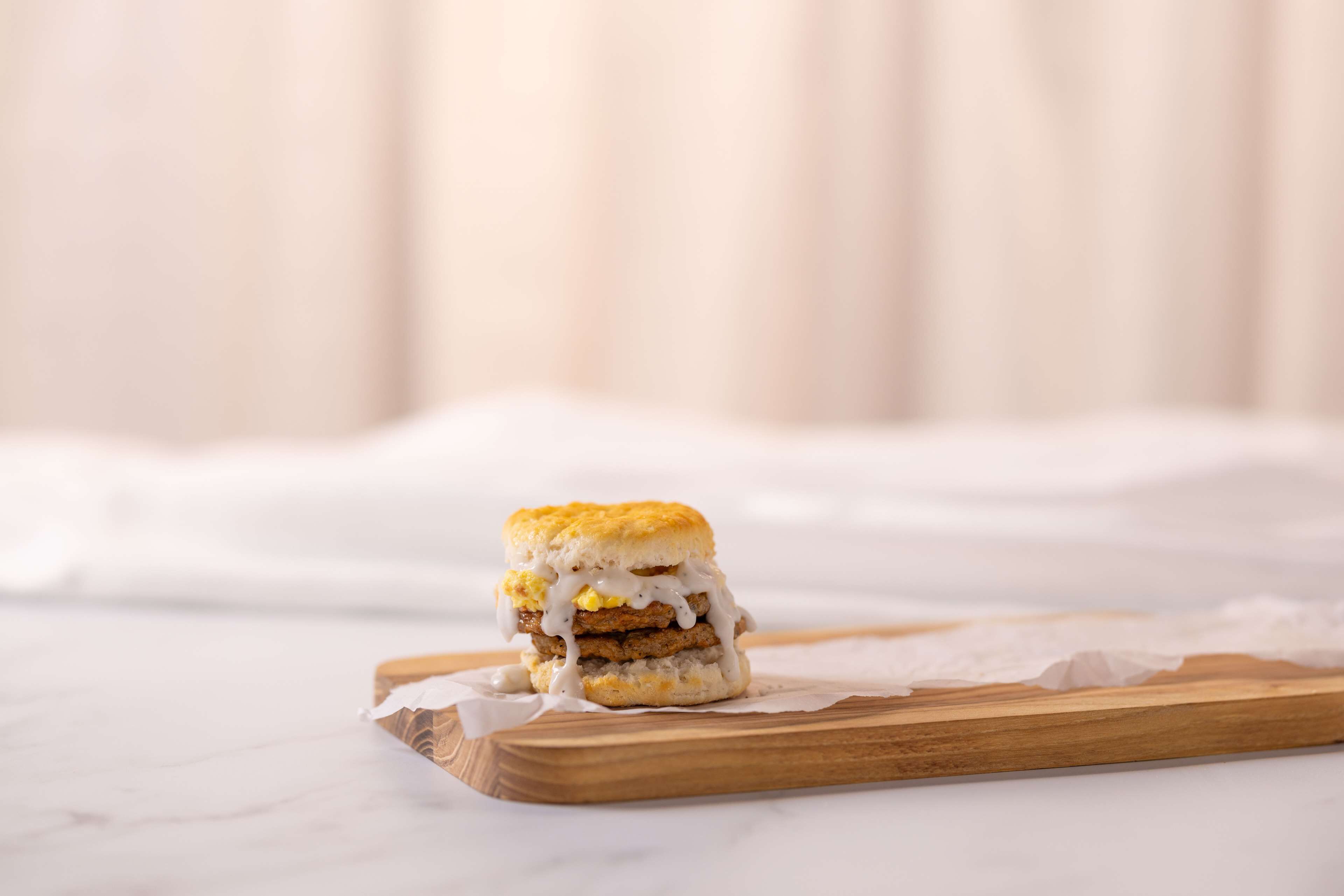 A sandwich on a wooden board.