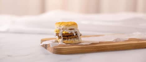 A sandwich on a wooden board.