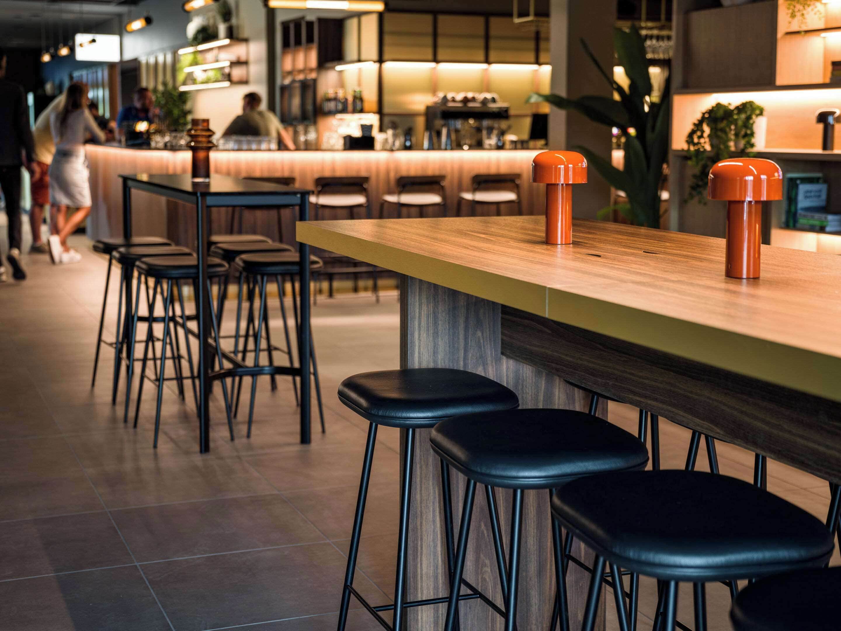 A bar area with stools and a counter.