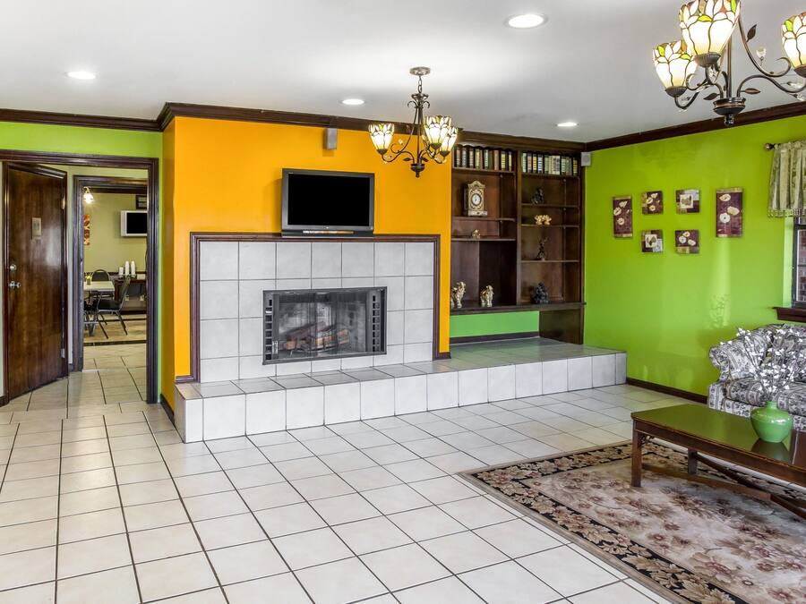 A living room with a fireplace, a television, and a sofa.
