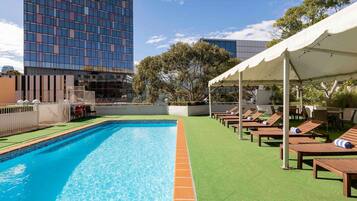 Outdoor pool, open 6:00 AM to 9:00 PM, pool loungers