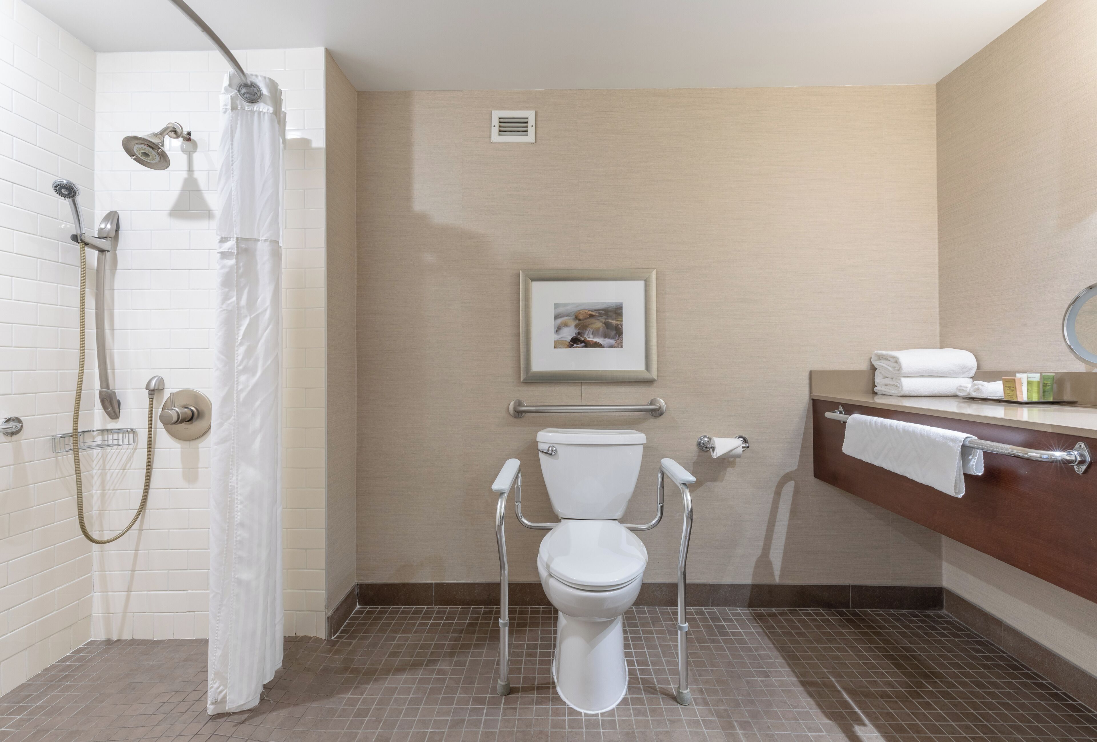 A bathroom with a shower, toilet, and sink.